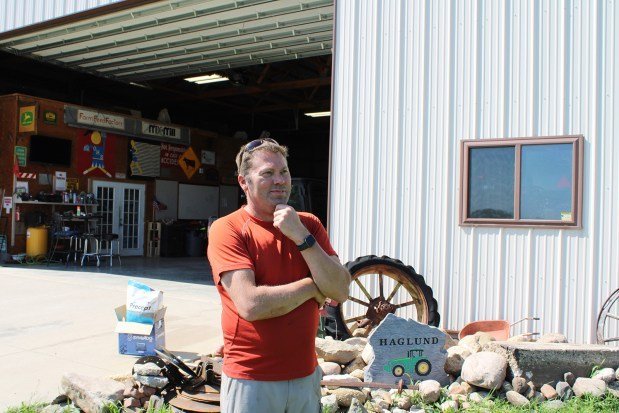 Mental health advocate Jason Haglund stands outside a machine shed on his family's farm near Boone, Iowa, on May 17, 2024. He has seen how farmers' traditional self-sufficiency can make them hesitate to seek help for mental stress. (Tony Leys/KFF Health News/TNS)