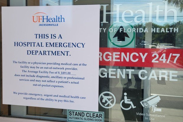 A sign on an urgent care center notes they could bill for emergency services