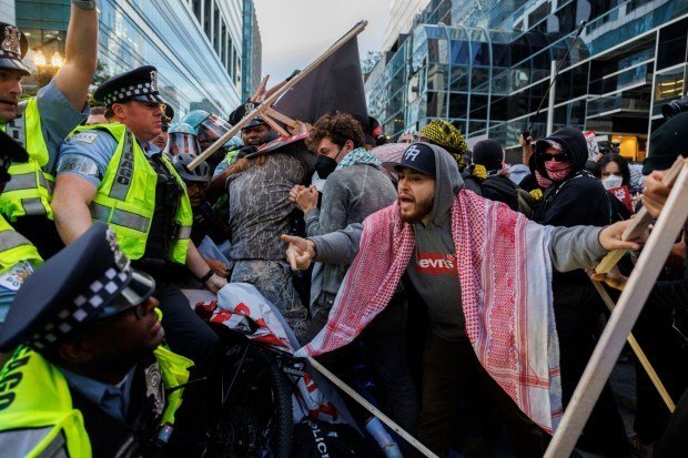 Activists scuffle with officers outside the Israeli Consulate while protesting the war in Gaza during the second day of the Democratic National Convention Tuesday Aug. 20, 2024, in Chicago. (Armando L. Sanchez/Chicago Tribune)