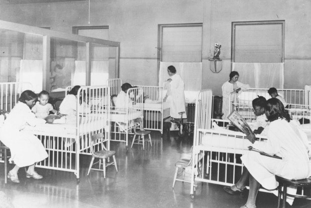 Nurses attend to patients in this historical photo of the children's ward inside Wheatley-Provident Hospital, a Black hospital in Kansas City, Missouri. It opened in 1918, but, like most Black hospitals, it closed following the federal campaign to desegregate hospitals in the 1960s. (Missouri Valley Special Collections/Kansas City Public Library/KFF Health News/TNS)