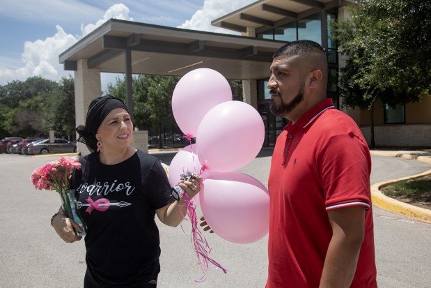Herlinda Sanchez heads back to her car with her husband, Manuel, after her final chemotherapy appointment at Texas Oncology. (Lisa Krantz/KFF Health News/TNS)